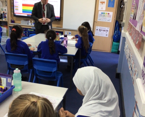 Bambos speaking to pupils at De Bohun Primary School