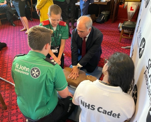 Bambos Charalambous MP learning lifesaving CPR skills with the St John Ambulance team in Parliament on Tuesday