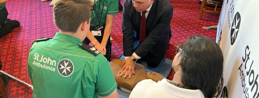 Bambos Charalambous MP learning lifesaving CPR skills with the St John Ambulance team in Parliament on Tuesday