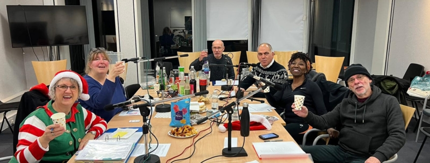 Bambos Charalambous MP pictured with the Enfield Talking Newspaper team during the festive edition recording